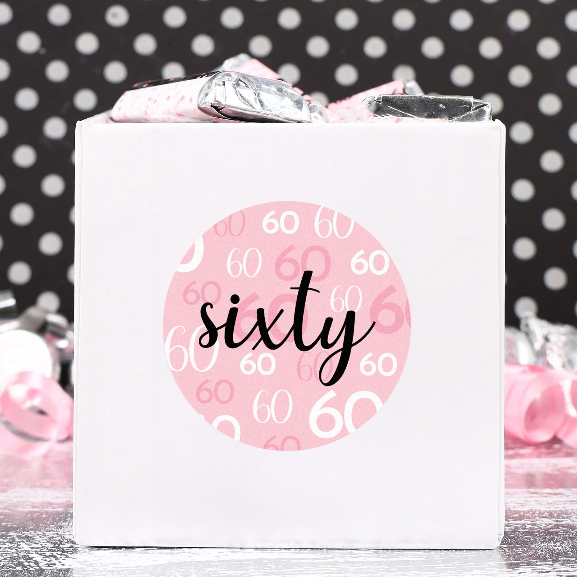 A close-up of a pink and black 60th birthday sticker with a stylish design, made in the USA and perfect for celebrating a milestone birthday.